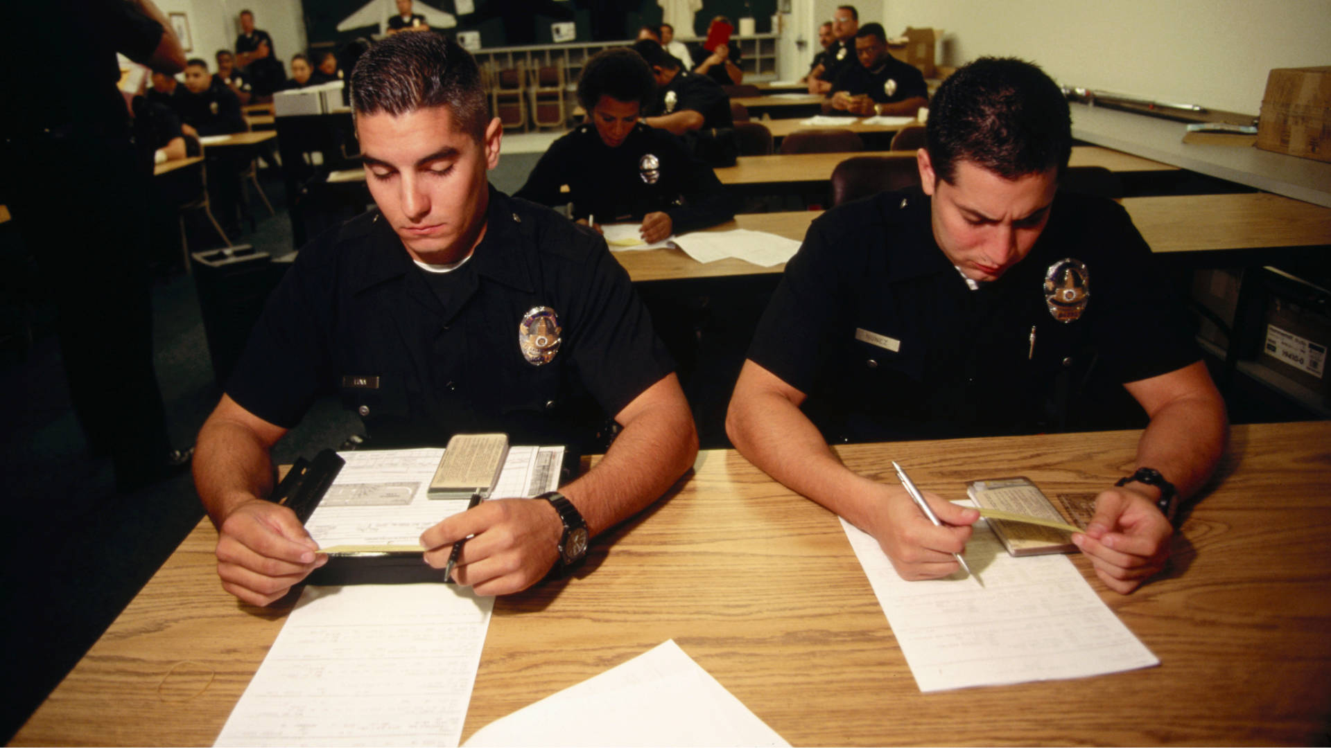 Two corrections officer studying notes and learning